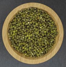 Green Peppercorns displayed in wooden bowl