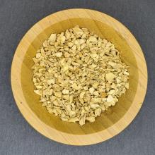 Bits of dried ginger cuts in wooden bowl